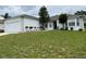 One-story house with a white exterior, attached garage, and well-maintained lawn at 325 Ashley Loop, Davenport, FL 33837