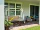 Charming patio area with a wooden swing and comfortable outdoor seating, ideal for enjoying the outdoors at 742 San Joaquin Rd, Poinciana, FL 34759