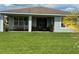 Relaxing covered patio features a swing, outdoor seating, and a well-manicured lawn, perfect for outdoor enjoyment at 742 San Joaquin Rd, Poinciana, FL 34759