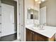 Clean bathroom with wood vanity and a large mirror at 154 Rancho Mirage Dr, Kissimmee, FL 34759