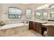 Elegant bathroom with a soaking tub and a double vanity at 154 Rancho Mirage Dr, Kissimmee, FL 34759