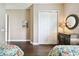 Bright bedroom with floral bedding, wood floors, and a large closet at 154 Rancho Mirage Dr, Kissimmee, FL 34759