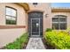 Inviting home exterior with a screened entryway and landscaping at 154 Rancho Mirage Dr, Kissimmee, FL 34759