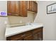 Laundry room with wood cabinets, countertop, and sink at 154 Rancho Mirage Dr, Kissimmee, FL 34759