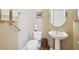 Clean powder room with pedestal sink, toilet, and tasteful decor at 154 Rancho Mirage Dr, Kissimmee, FL 34759