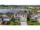 Two-story house with solar panels, lake view, and manicured lawn at 6718 Grace Hammock Rd, Harmony, FL 34773