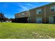 Townhome backyard with green grass and screened-in porch at 721 Interlude Ln # 105, Orlando, FL 32824