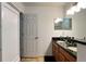 The bathroom has double sinks and a dark granite countertop vanity at 721 Interlude Ln # 105, Orlando, FL 32824