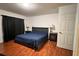 Well-lit bedroom features a full sized bed, hardwood floors and simple furnishings at 721 Interlude Ln # 105, Orlando, FL 32824