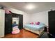 Cozy bedroom featuring a queen bed, mirror, and dark curtains at 721 Interlude Ln # 105, Orlando, FL 32824