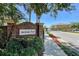 Jackson Park entrance with brick sign, well-maintained landscaping and controlled-access gate at 721 Interlude Ln # 105, Orlando, FL 32824