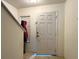Entryway with a white front door and side window, showcasing a bright and inviting space at 721 Interlude Ln # 105, Orlando, FL 32824