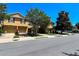 Exterior of townhomes on a sunny day featuring manicured lawns and mature trees at 721 Interlude Ln # 105, Orlando, FL 32824