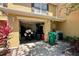 Garage entrance with motorcycle, storage, and garbage bins at 721 Interlude Ln # 105, Orlando, FL 32824