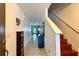 Hallway with staircase and tiled floor, leading to the living room and front door at 721 Interlude Ln # 105, Orlando, FL 32824
