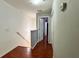 Second-floor hallway features hard wood, white walls, closet, and neutral paint at 721 Interlude Ln # 105, Orlando, FL 32824