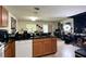 Spacious kitchen features granite counters, tile flooring, a modern faucet and dishwasher at 721 Interlude Ln # 105, Orlando, FL 32824