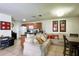 Spacious living room with comfortable seating, tile flooring and open to the kitchen at 721 Interlude Ln # 105, Orlando, FL 32824