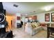 Open concept living space with tile floors and kitchen with bar seating and light colored couch at 721 Interlude Ln # 105, Orlando, FL 32824
