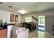 Bright living room with cozy seating, dining table, and sliding glass doors to the outdoors at 721 Interlude Ln # 105, Orlando, FL 32824