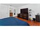 Spacious main bedroom with hardwood floors, tv, walk-in closet and full bathroom at 721 Interlude Ln # 105, Orlando, FL 32824
