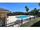 Community pool features a sparkling pool surrounded by lounge chairs, tables, and well-manicured landscaping at 721 Interlude Ln # 105, Orlando, FL 32824