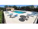 Community pool with sun loungers and tables, perfect for relaxation and socializing at 721 Interlude Ln # 105, Orlando, FL 32824