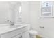 Clean and bright bathroom with white vanity and tile flooring at 907 Heirloom Dr, Haines City, FL 33844