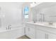 Double vanity and garden tub in an elegant Primary bathroom at 907 Heirloom Dr, Haines City, FL 33844