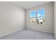 Bright bedroom with neutral walls, carpet, and large window at 911 Heirloom Dr, Haines City, FL 33844