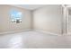 Simple bedroom with light walls, tile flooring and a window at 911 Heirloom Dr, Haines City, FL 33844