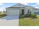 Curb appeal of a single-Gathering home with a two-car garage and neatly kept lawn at 911 Heirloom Dr, Haines City, FL 33844