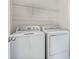 Laundry room with washer, dryer and shelving at 911 Heirloom Dr, Haines City, FL 33844