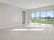 Bright living room with tile floors, sliding doors, and a pond view at 911 Heirloom Dr, Haines City, FL 33844