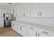 Stylish kitchen showcasing sleek white cabinets, modern hardware, and ample counter space at 922 Heirloom Dr, Haines City, FL 33844