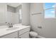 Bathroom with white vanity, toilet and a window at 930 Heirloom Dr, Haines City, FL 33844