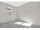 Well-lit bedroom featuring grey carpet and a window at 930 Heirloom Dr, Haines City, FL 33844