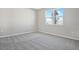 Bright bedroom with grey carpet and large window at 930 Heirloom Dr, Haines City, FL 33844