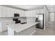 Modern kitchen with white cabinets, stainless steel appliances, and an island at 930 Heirloom Dr, Haines City, FL 33844