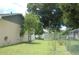 Large backyard with mature trees and chain link fence at 267 Cranbrook Dr, Kissimmee, FL 34758