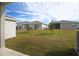 Spacious backyard with grassy area and homes at 1706 Sugarbelle Cir, Mascotte, FL 34753