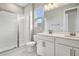 Bright bathroom with double vanity, shower, and toilet at 1706 Sugarbelle Cir, Mascotte, FL 34753