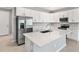 Modern kitchen with stainless steel appliances and white cabinets at 1706 Sugarbelle Cir, Mascotte, FL 34753