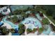 An aerial view of a resort community highlighting the lazy river, pool, cabanas, and tennis court at 1921 Nice Ct, Kissimmee, FL 34747