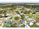 Wide aerial shot showcasing the home's location within a tranquil neighborhood with verdant landscapes at 435 Lantern Dr, Kenansville, FL 34739