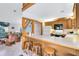 Open-concept kitchen with counter seating, view of the living area, and tile flooring at 435 Lantern Dr, Kenansville, FL 34739