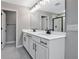 Modern bathroom with double vanity, white cabinets, and a walk-in shower at 1446 Maddie Berry Ln, Kissimmee, FL 34744