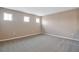 Simple bedroom with grey carpet and multiple windows at 1446 Maddie Berry Ln, Kissimmee, FL 34744