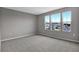 Spacious bedroom with large windows and grey carpet at 1446 Maddie Berry Ln, Kissimmee, FL 34744