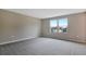 Spacious bedroom with neutral walls and carpet, featuring two large windows at 1446 Maddie Berry Ln, Kissimmee, FL 34744